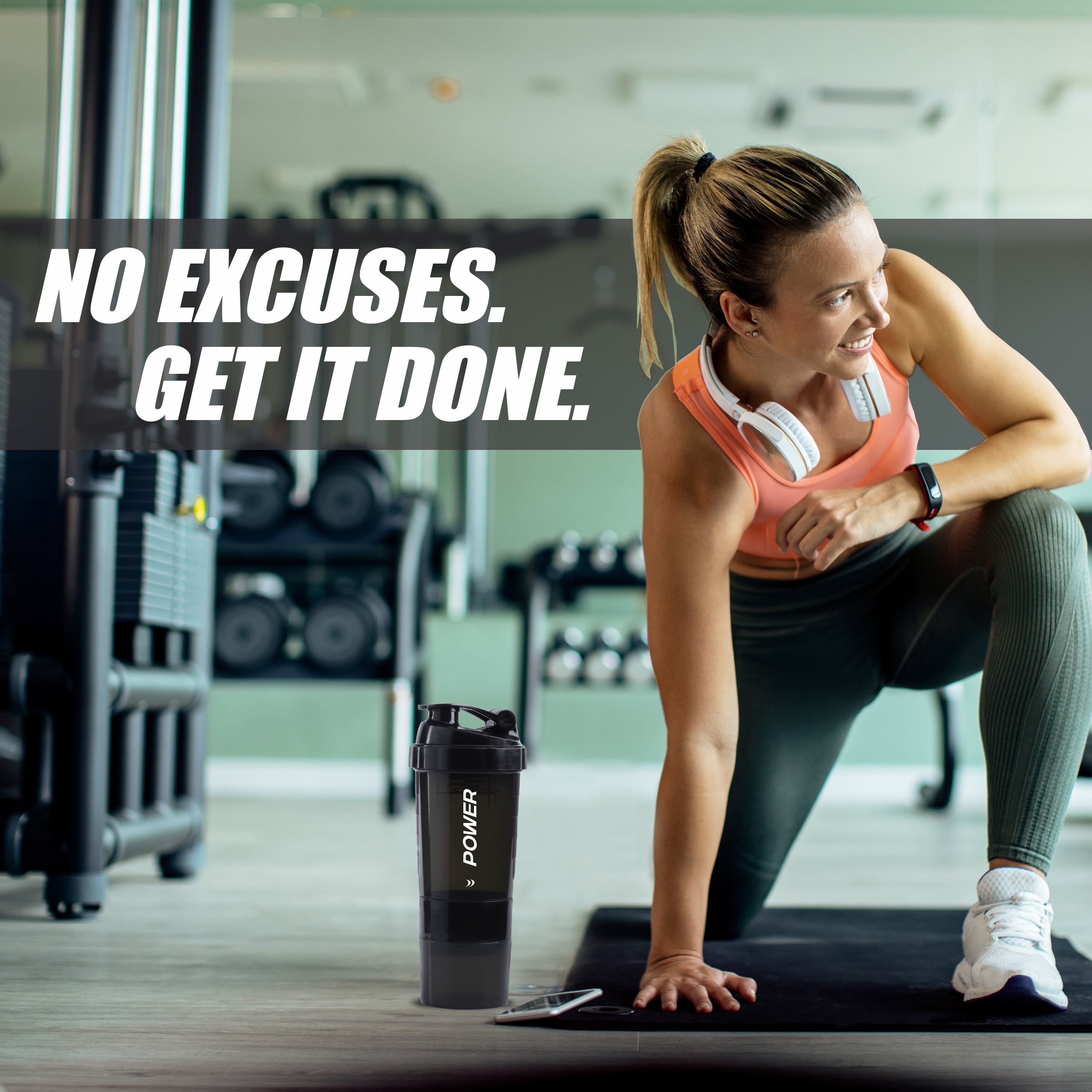 A woman sits on a bench holding a water bottle, embodying strength and hydration in a fitness-focused environment.